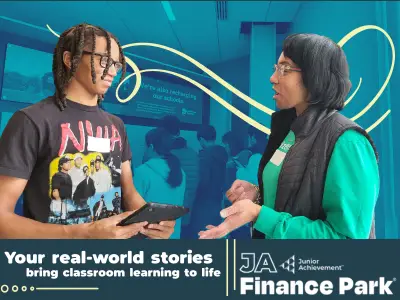 A volunteer discussing average car prices with a student